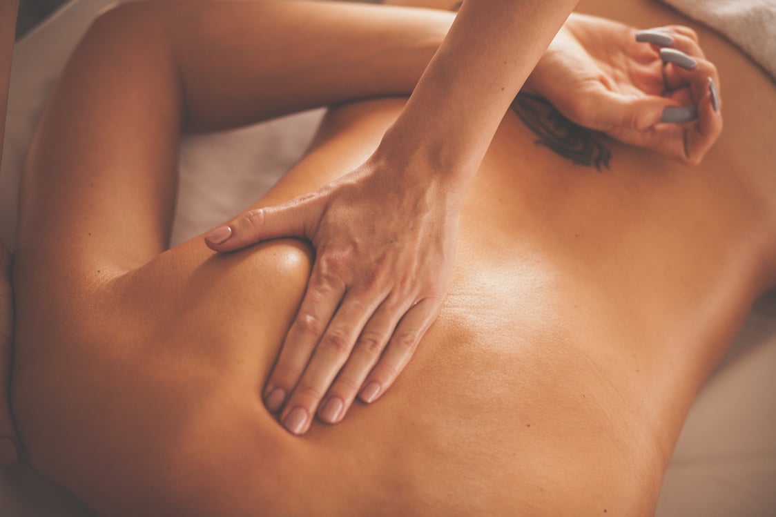 Woman receiving deep tissue massage at spa